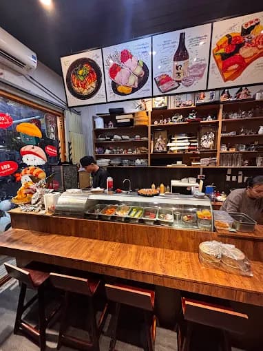 Suika Sushi counter with wooden seating and display shelves