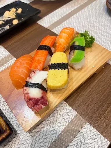Nigiri arranged on a wooden serving board